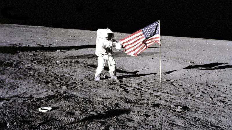 U.S, Flag On The Moon, Apollo 12 Astronaut Charles 'Pete' Conrad Stands Beside The U.S, Flag After It Was Unfurled On The Lunar Surface On Nov, 19, 1969, Footprints Made By The Crew Can Be Seen In The Photograph. (Photo By Encyclopaedia Britannica/UIG Via